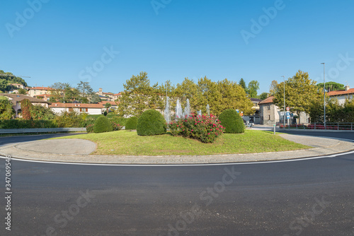 Traffic roundabout on a road in a typical Italian village. Calcinate del Pesce (provincial road 1 – SP1) is a village on lake Varese, province of Varese, northern Italy 