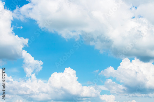 Bright fluffy clouds in light blue sky