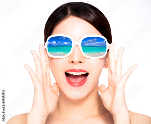 happy young beauty in sunglasses with beach reflection