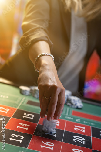 Woman playing roulette at the casino