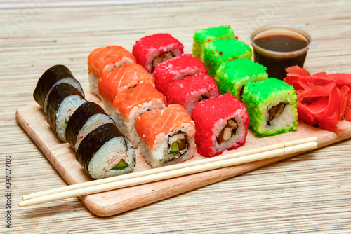 sushi rolls set served on wooden tray photo