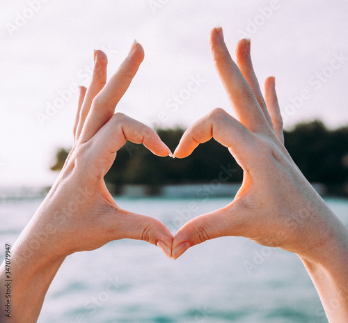 Woman making a heart shape with her hands and fingers