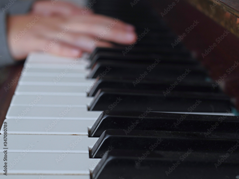 Practicing on piano, Teenager's hand, black and white keys, Concept developing finger's motion skill,