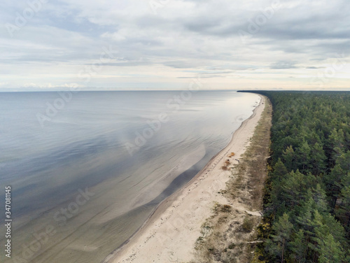 Aerial view on empty Jurmala beach, Cloudy sky, Green forest, nobody. Latvia.