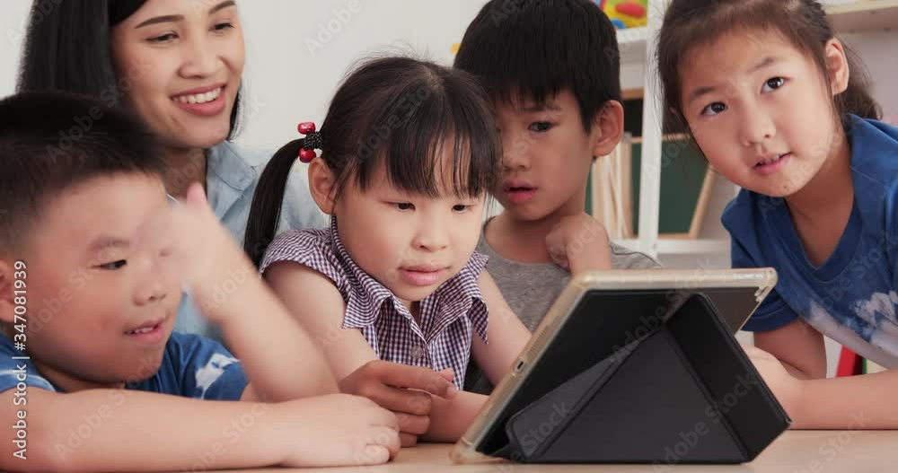 Group of children looking to tablet together. Education, Study, Technology and Lifestyle concept. Group of children looking to tablet together. Education, Study, Technology and Lifestyle concept.