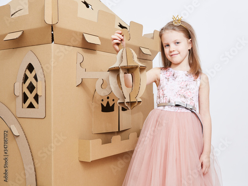 The princess play with cardboard castle tower. photo