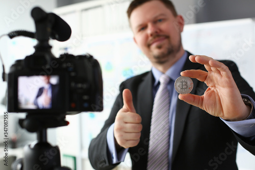 Business trainer hold silver bitcoin in hand