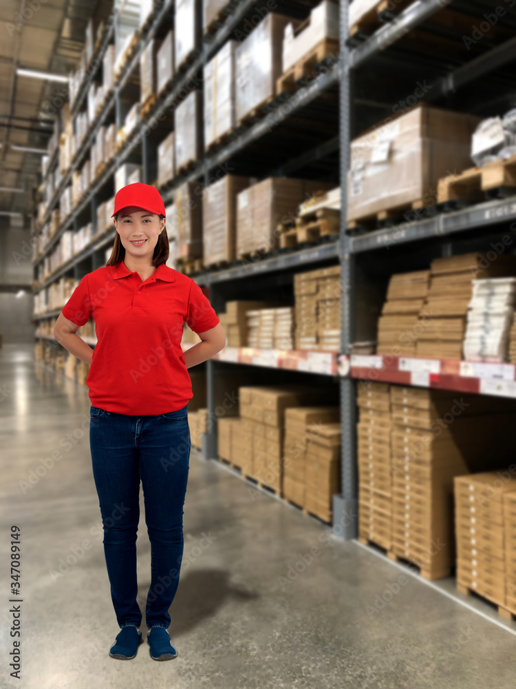 Woman operator in uniform with Blurred the background of the warehouse storage Woman operator in uniform with Blurred the background of the warehouse storage
