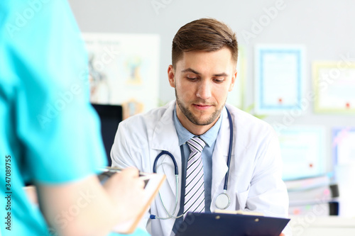 Thoughtful doctor reading documents