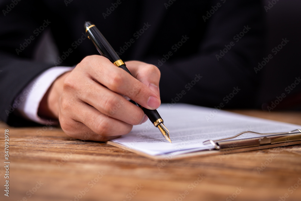 Serious business man working on documents looking concentrated with briefcase. Serious business man working on documents looking concentrated with briefcase.
