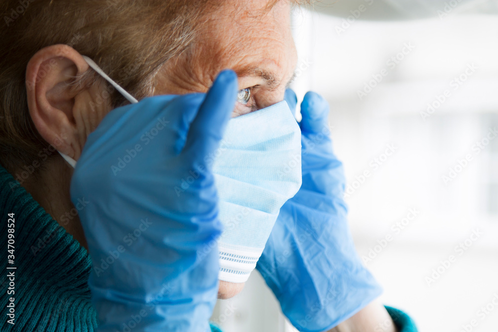 Naklejka premium portrait of senior woman with disposable medical mask. Safety in public places during coronavirus outbreak.