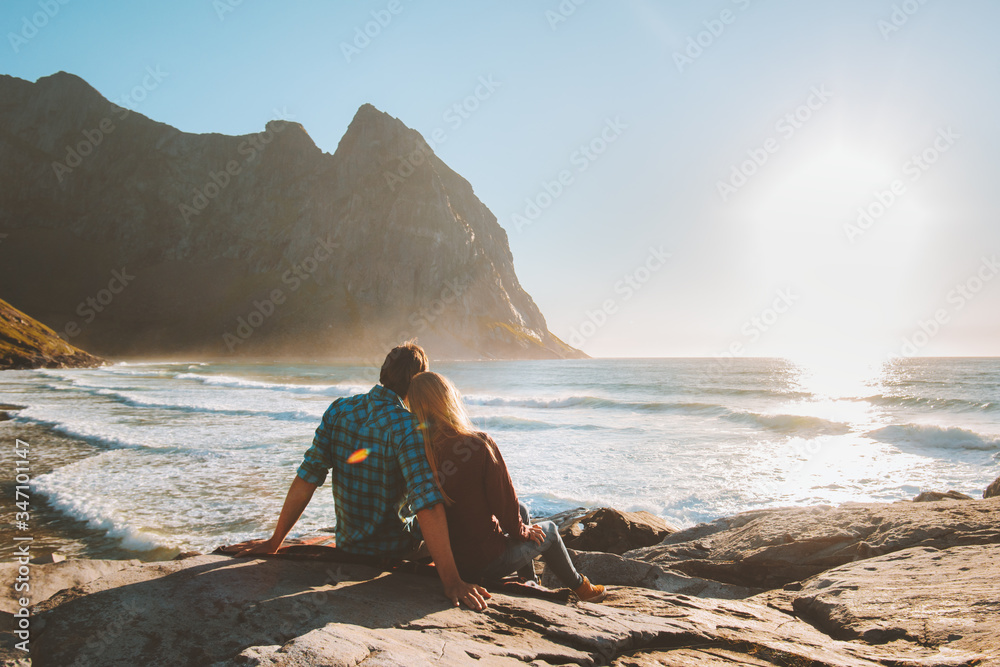 Couple in love romantic vacations family travel happy moments outdoor lifestyle relationship man and woman together enjoying Kvalvika beach and rocks landscape in Norway summer trip