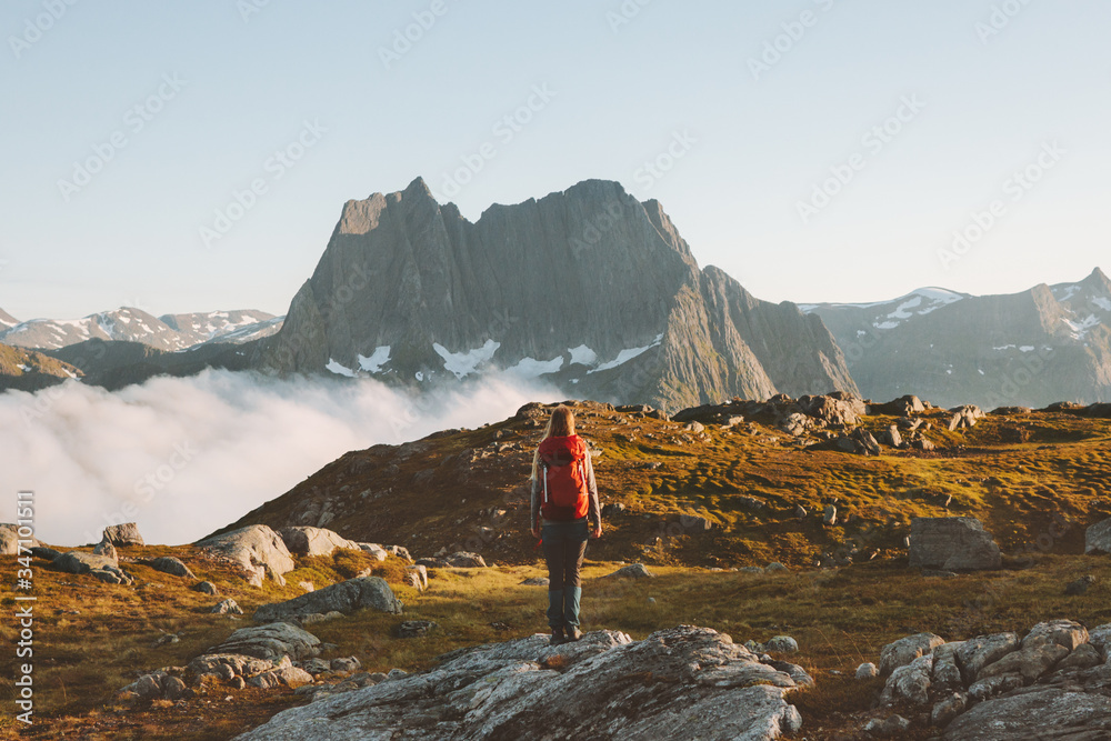 Woman backpacker hiking in mountains adventure travel extreme vacation healthy lifestyle outdoor eco tourism in Norway summer activity