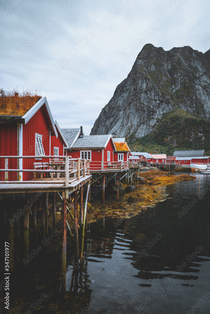 Norway red wooden houses Reine village in Lofoten islands traditional rorbu  and rocky mountains scandinavian architecture norwegian landscape Stock  Photo | Adobe Stock