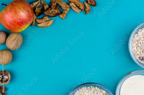 oatmeal with dried berries surrounded by nuts and dried fruits