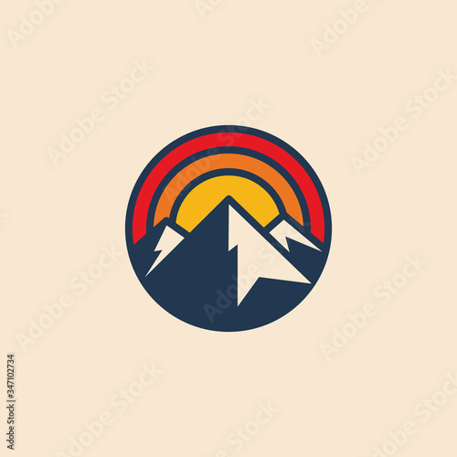 Minimalistic circular mountain logo icon design template with mountain peak and sunset. Vintage styled vector illustration.