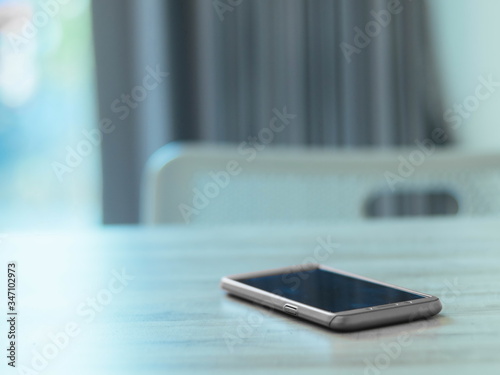 gray mobile phone placed on a blue table