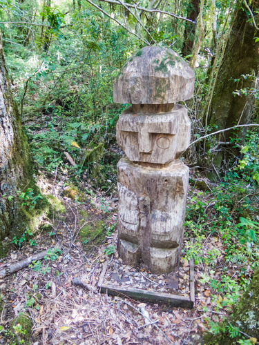 Wooden statue, in the middle of the Huilo Huilo Biological Reserve, regressing animals and Mapuche mystical characters from southern Chile photo