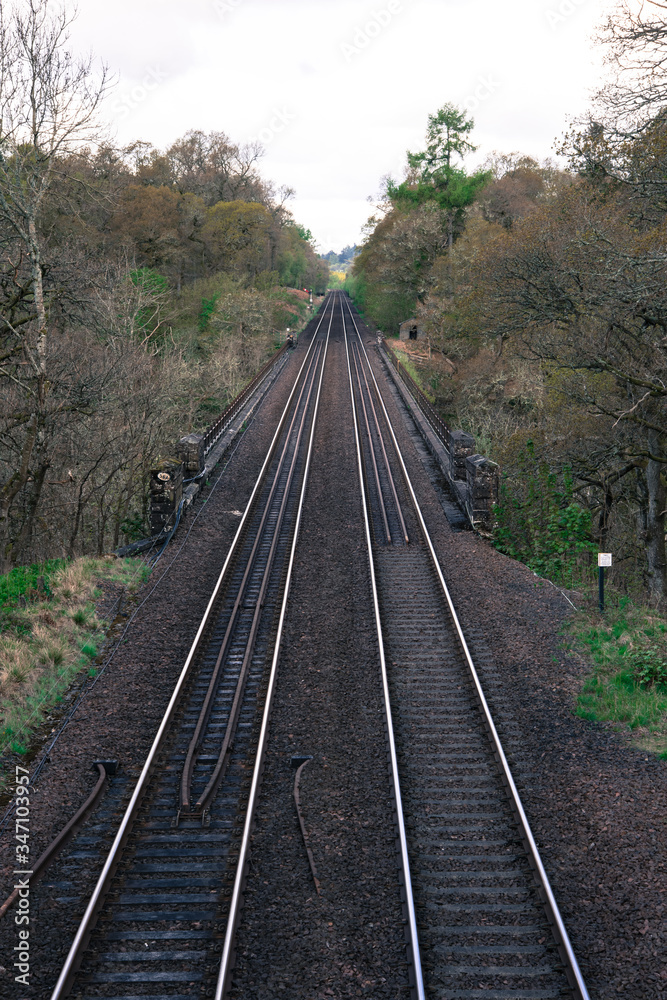 Railway, Railroad, Train Tracks - sad double train tracks in rural area Railway, Railroad, Train Tracks - sad double train tracks in rural area