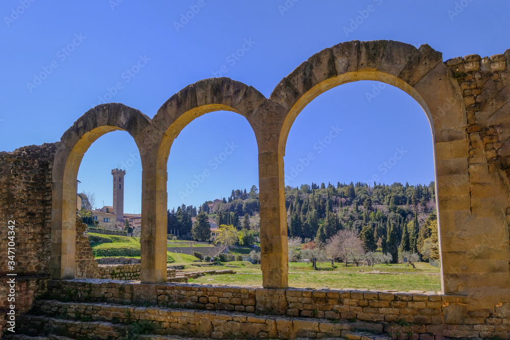 Close up of the preserved roman arches and the tower of the San Romolo Cathedral, Fiesole, Florence, Tuscany, Italy