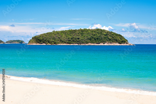 Turquoise Sea and White Sand Beach at Nai Harn Beach with Ko Man Island Background in Summer  Phuket  Thailand