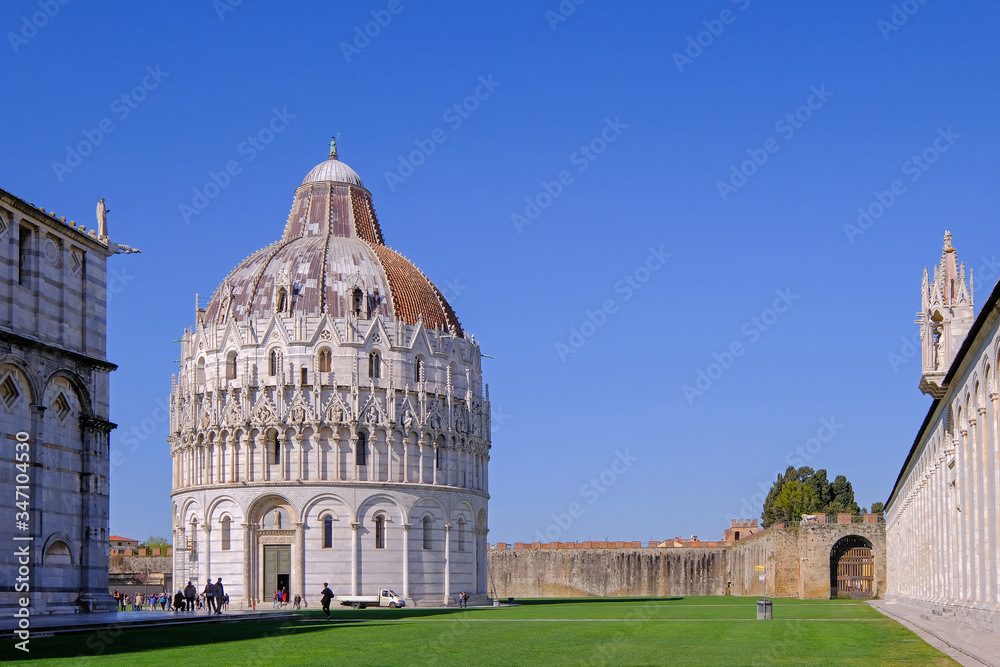 The baptistery at the Piazza Dei Miracoli with the famous Leaning Tower and the dome, Pisa, Tuscany, Italy