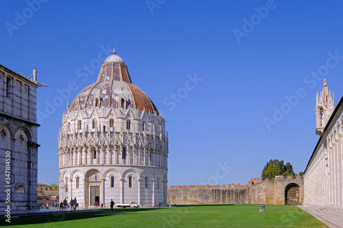 The baptistery at the Piazza Dei Miracoli with the famous Leaning Tower and the dome  Pisa  Tuscany  Italy