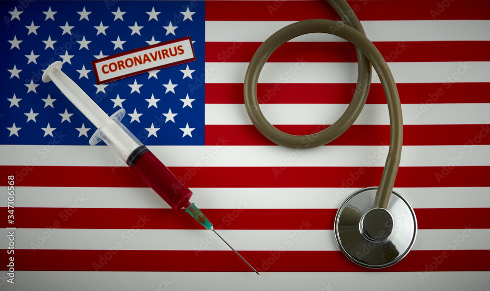 Stethoscope and syringe on USA flag with coronavirus label