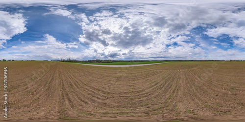 full seamless spherical hdri panorama 360 degrees angle view on among fields in spring evening with awesome clouds before storm in equirectangular projection, ready for VR AR virtual reality content