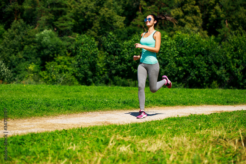 Athletic happy brunette woman working out in a meadow Athletic happy brunette woman working out in a meadow