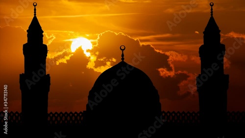 Mosque Qiblatain in Medina, Saudi Arabia: Time Lapse at Sunset with Red Sun and Fiery Clouds photo