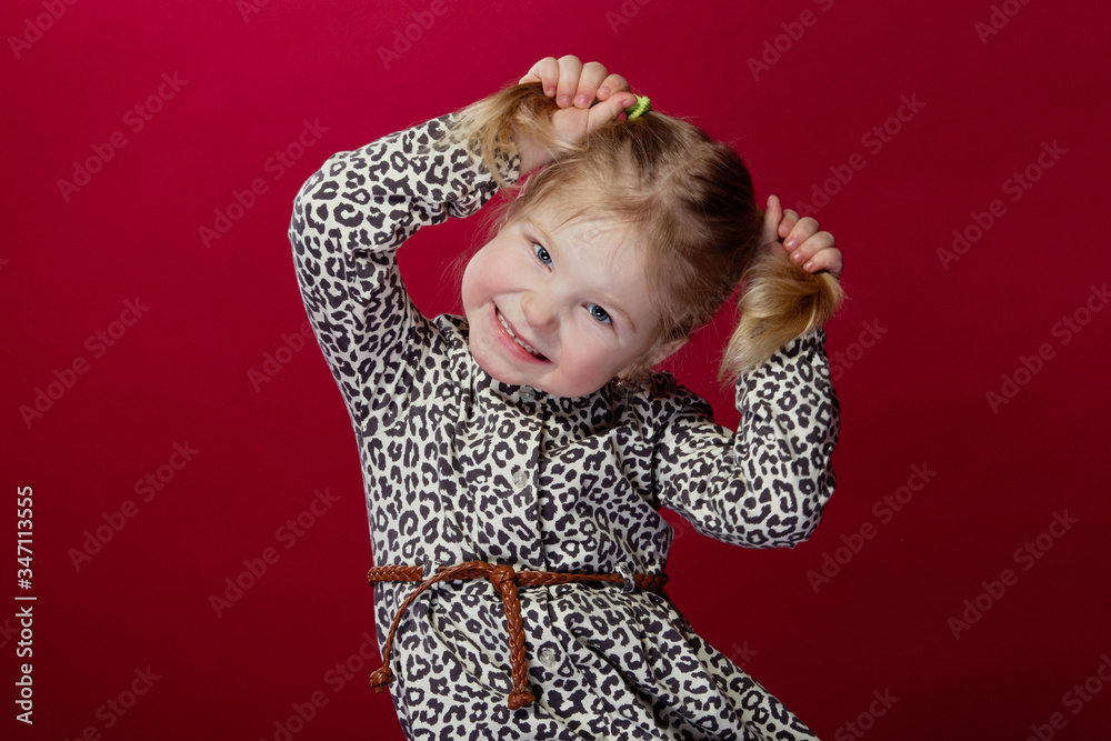 little girl plays and laughs, holds pens on her tails and smiles little girl plays and laughs, holds pens on her tails and smiles