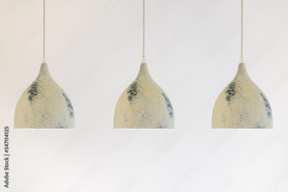 three ceiling lights on a long wire hanging from the ceiling on a white background three ceiling lights on a long wire hanging from the ceiling on a white background