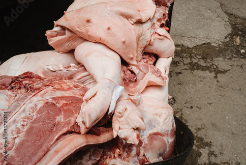 The pieces of the pigs slaughtered from the slaughterhouse were stacked on top of each other. Prepare to be transported for sale in the fresh market. photo