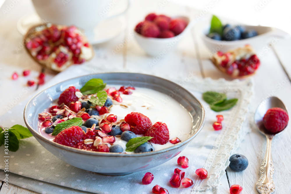Yogurt with fresh fruit and cereals in a bowl, healthy breakfast Yogurt with fresh fruit and cereals in a bowl, healthy breakfast