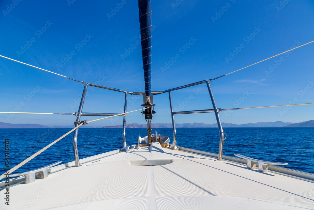 The front bow of a white sailing boat with blue sky and sea background. Love in blue with copy space The front bow of a white sailing boat with blue sky and sea background. Love in blue with copy space