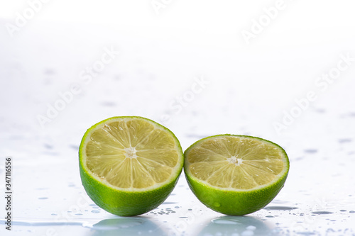 lime with splashes and streams of water on a black or white background isolated