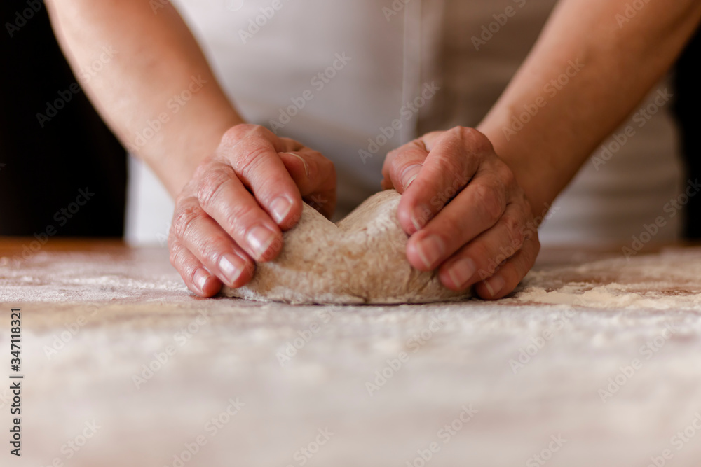 a person kneading the whole pizza dough a person kneading the whole pizza dough