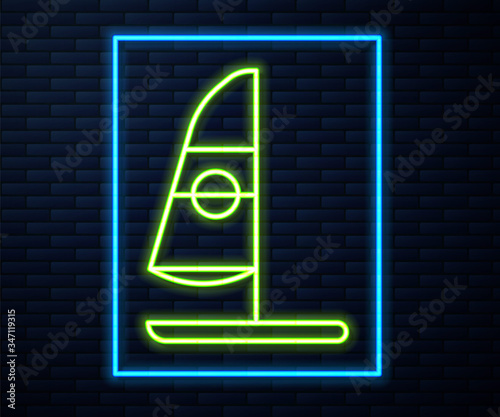 Glowing neon line Windsurfing icon isolated on brick wall background.  Vector Illustration