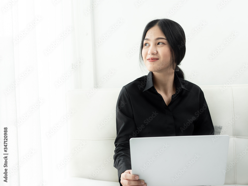 Asian woman in blank using laptop sitting on sofa at home, quarantine concept. Asian woman in blank using laptop sitting on sofa at home, quarantine concept.