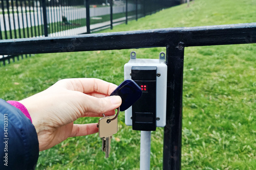 Obraz na plátně A person holding attaching key fob to open door