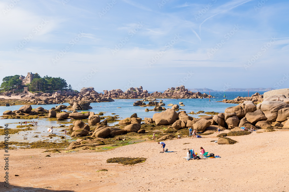 Perros-Guirec, France. Tourists on the beach on the Pink Granite Coast (Côte de granit rose)
