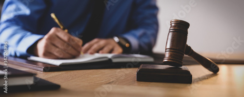 Wallpaper Mural Male lawyer working at table in office, focus on gavel. Banner design Torontodigital.ca