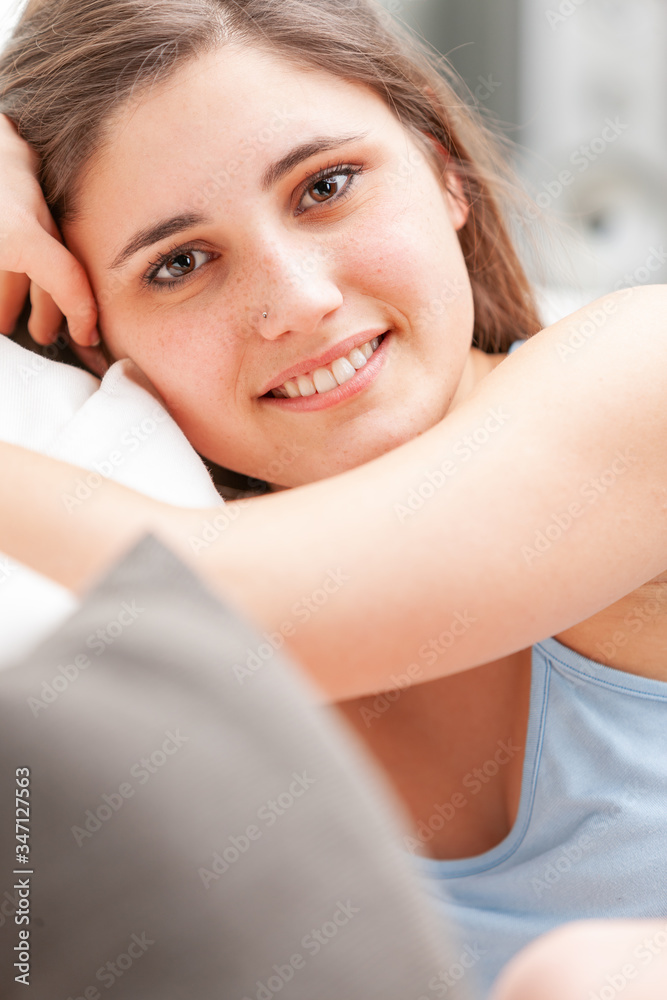 Attractive friendly young woman relaxing on a sofa Attractive friendly young woman relaxing on a sofa