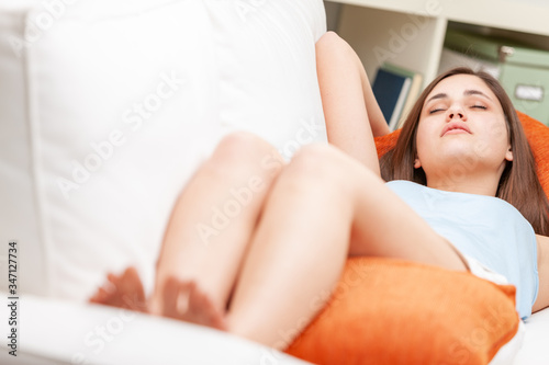 Young teenage girl taking a nap on the sofa