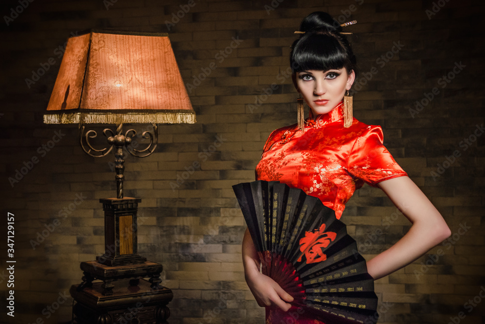 girl in a red Japanese silk dress qipao in a dark room Stock Photo | Adobe  Stock