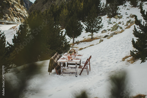 Close up of romantic wedding table in the middle of the mountain. Winter wedding decor.