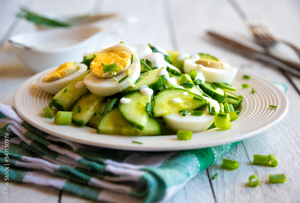 Healthy green salad with cucumbers, eggs and onions Healthy green salad with cucumbers, eggs and onions