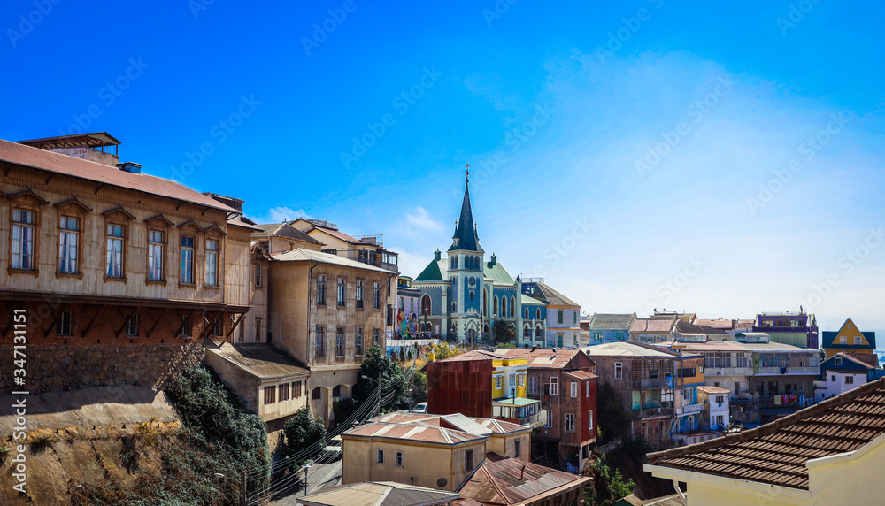 Valparaiso, Chile - March 08, 2020: Far View to the Cathedral and Colored Buildings with Bright Painting on the Street