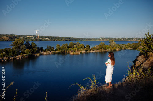girl in a long dress on a background of water  lake career